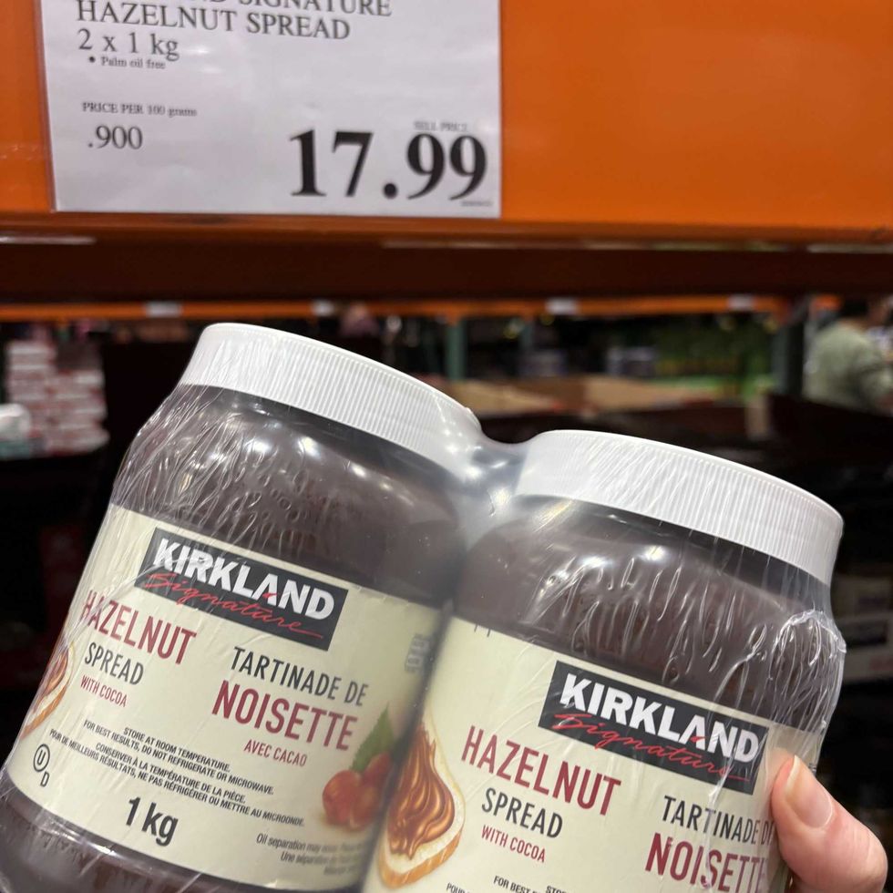person holding pack of Kirkland Signature hazelnut spread at costco