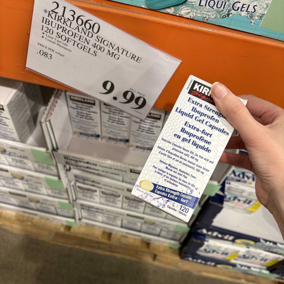 person holding pack of \u200b\u200bKirkland Signature extra-strength ibuprofen at costco