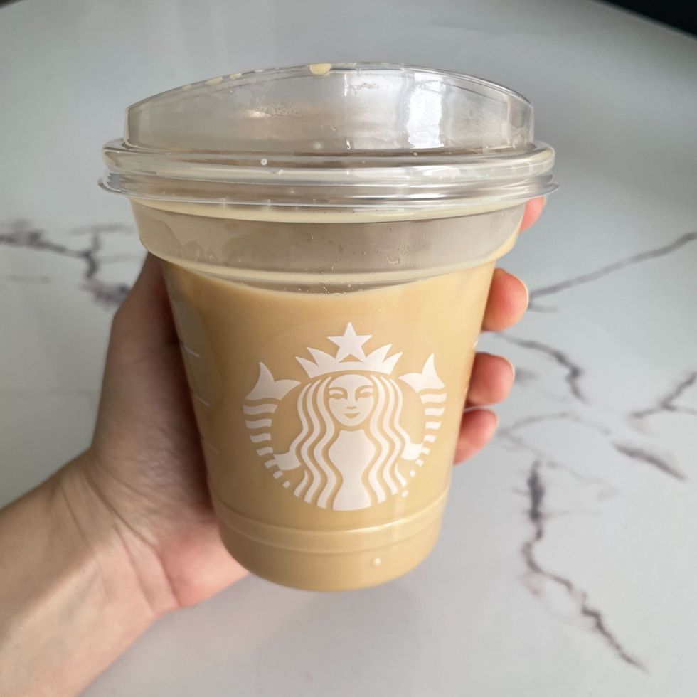 person holding starbucks iced coffee