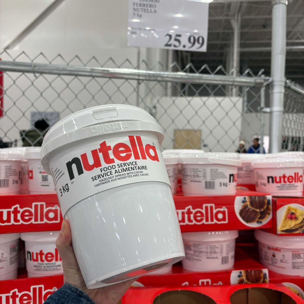 person holding tub of nutella at costco business centre