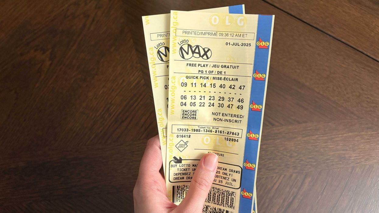 person holding two lotto max tickets from olg