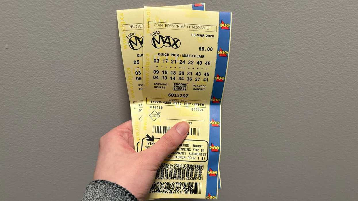 person holding two lotto max tickets from olg