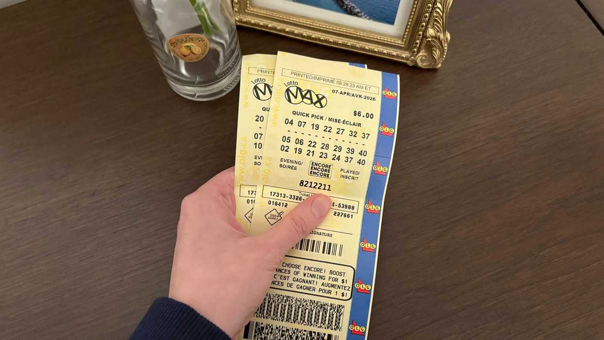 person holding two lotto max tickets from olg