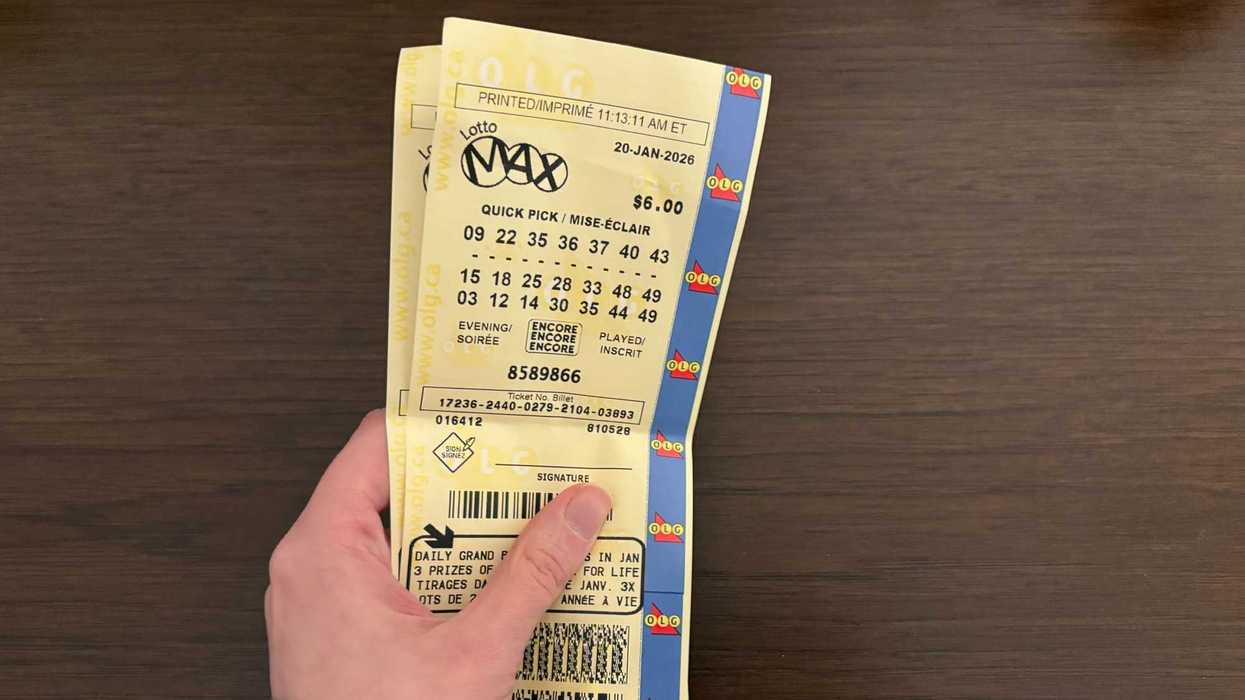person holding two lotto max tickets from olg