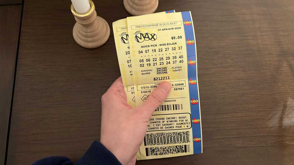 person holding two lotto max tickets from olg