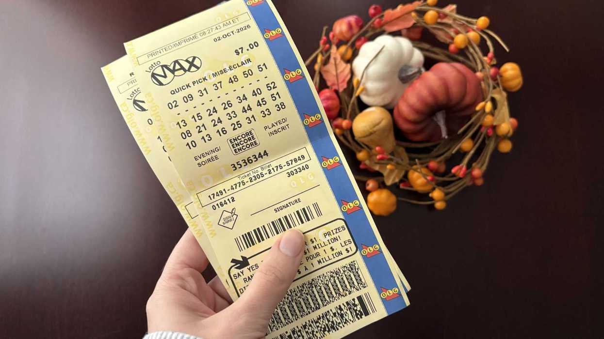 person holding two lotto max tickets from olg