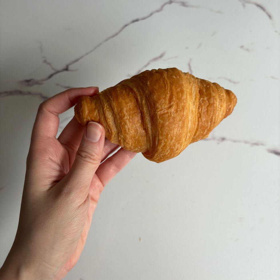 person holding walmart croissant