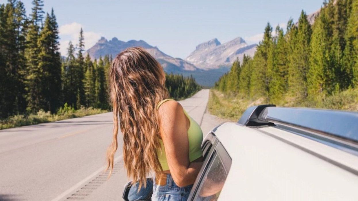 Person in a car looking at the mountains.