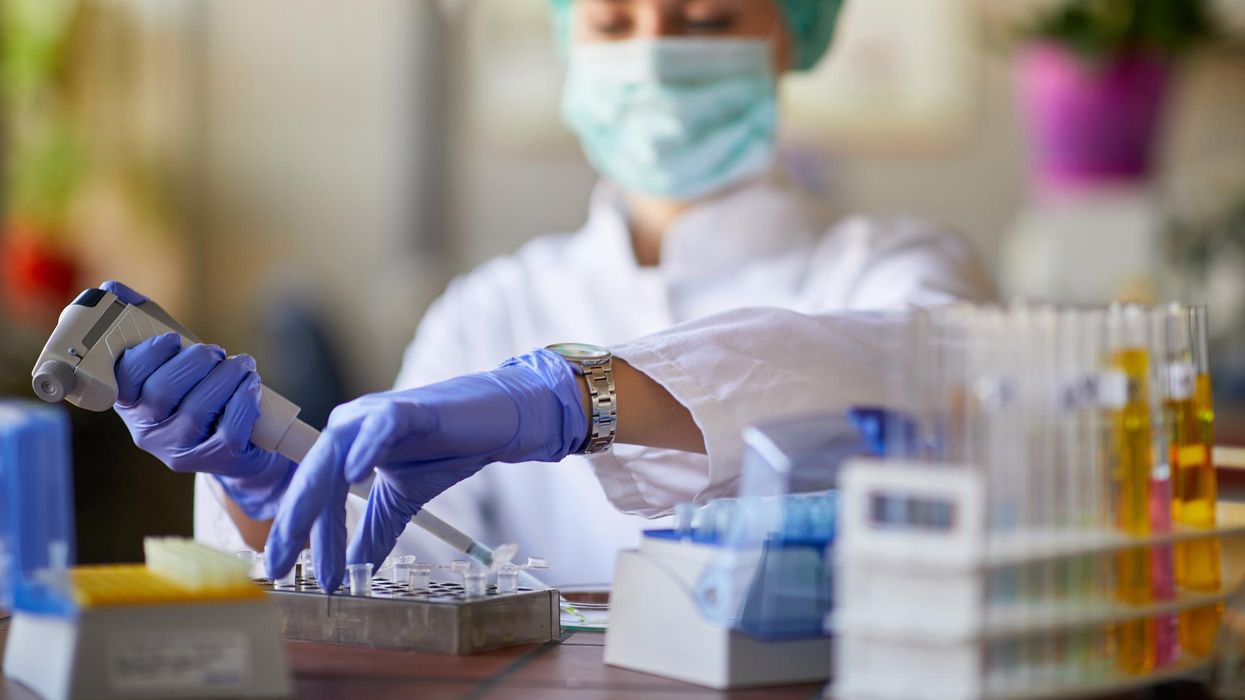 Person in a laboratory testing a sample.