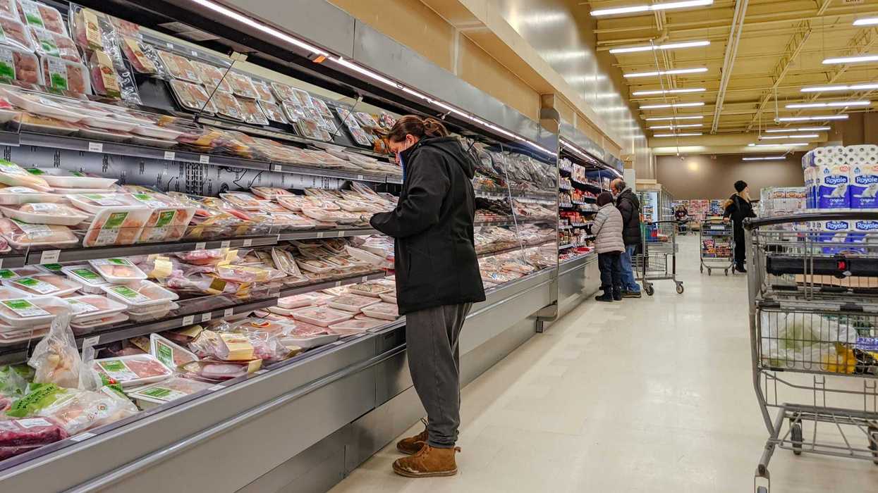 person looking at meat products at a grocery store in ontario