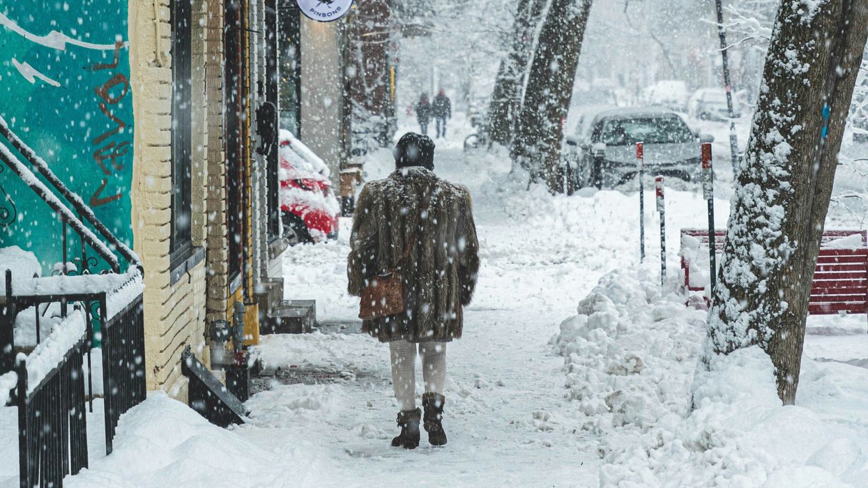 person on a sidewalk during a snowstorm
