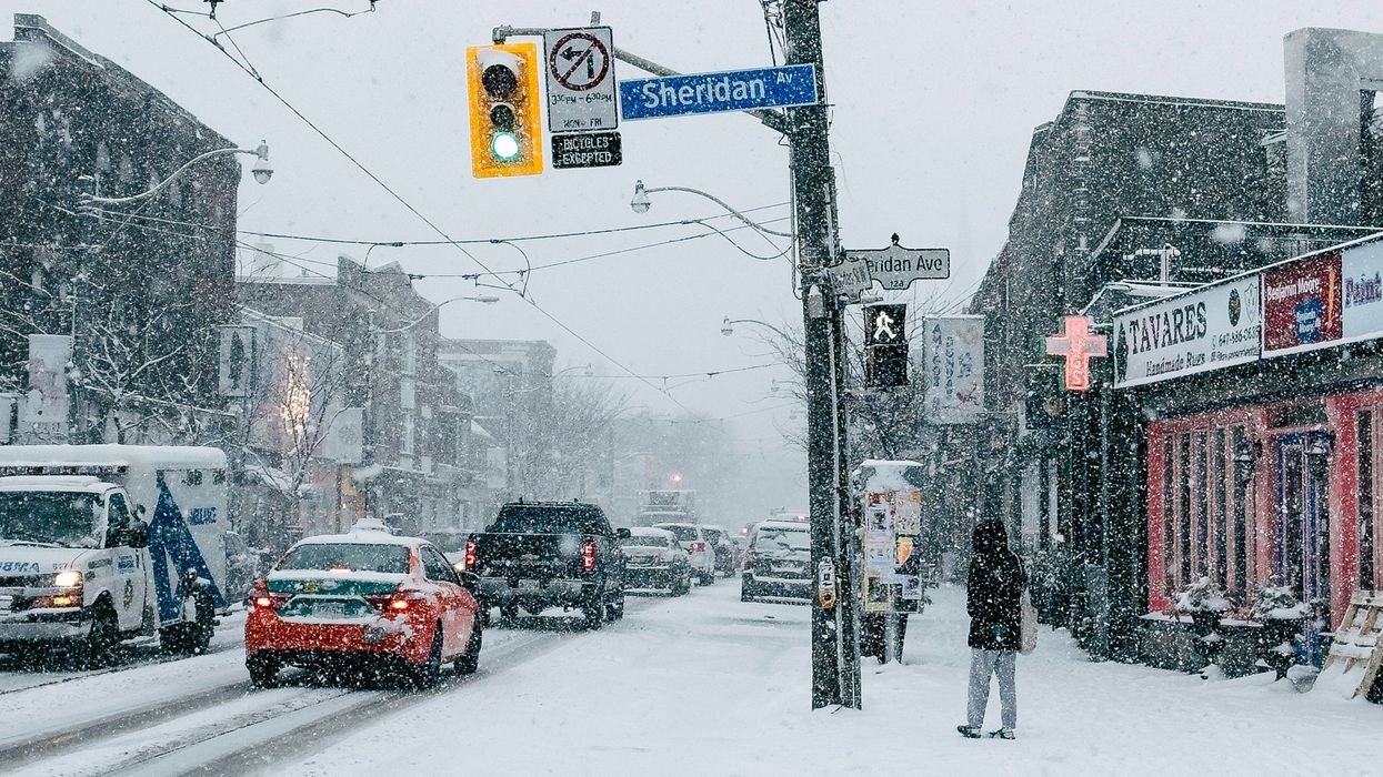 person on toronto street during a snowstorm