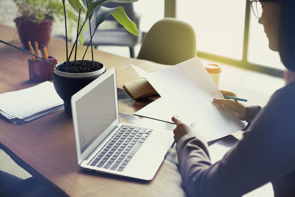Person sitting at a desk with a laptop.