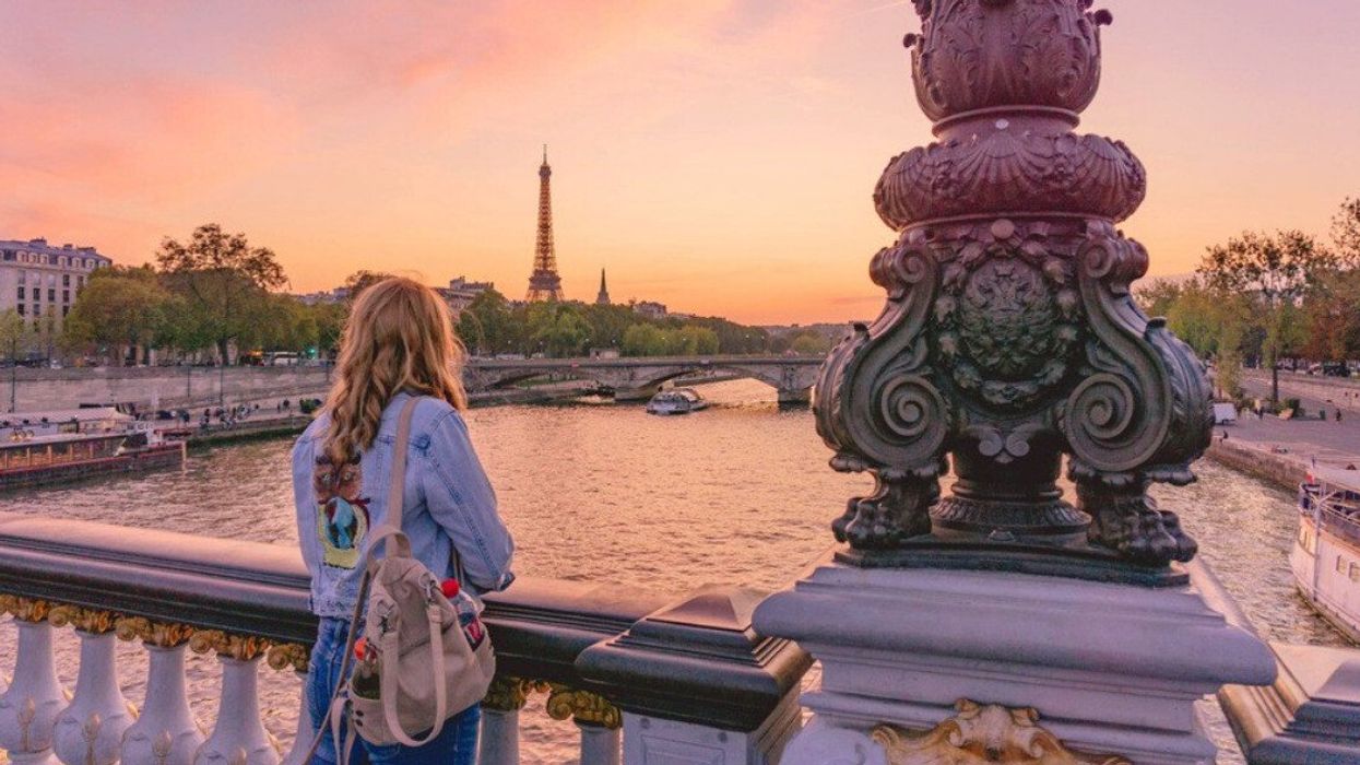 Person standing on a bridge in Paris, France.