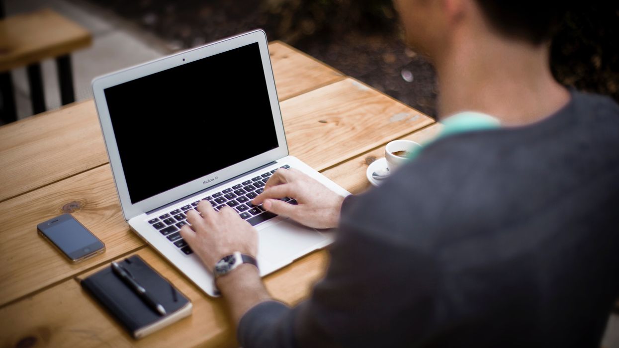 Person typing on a laptop.