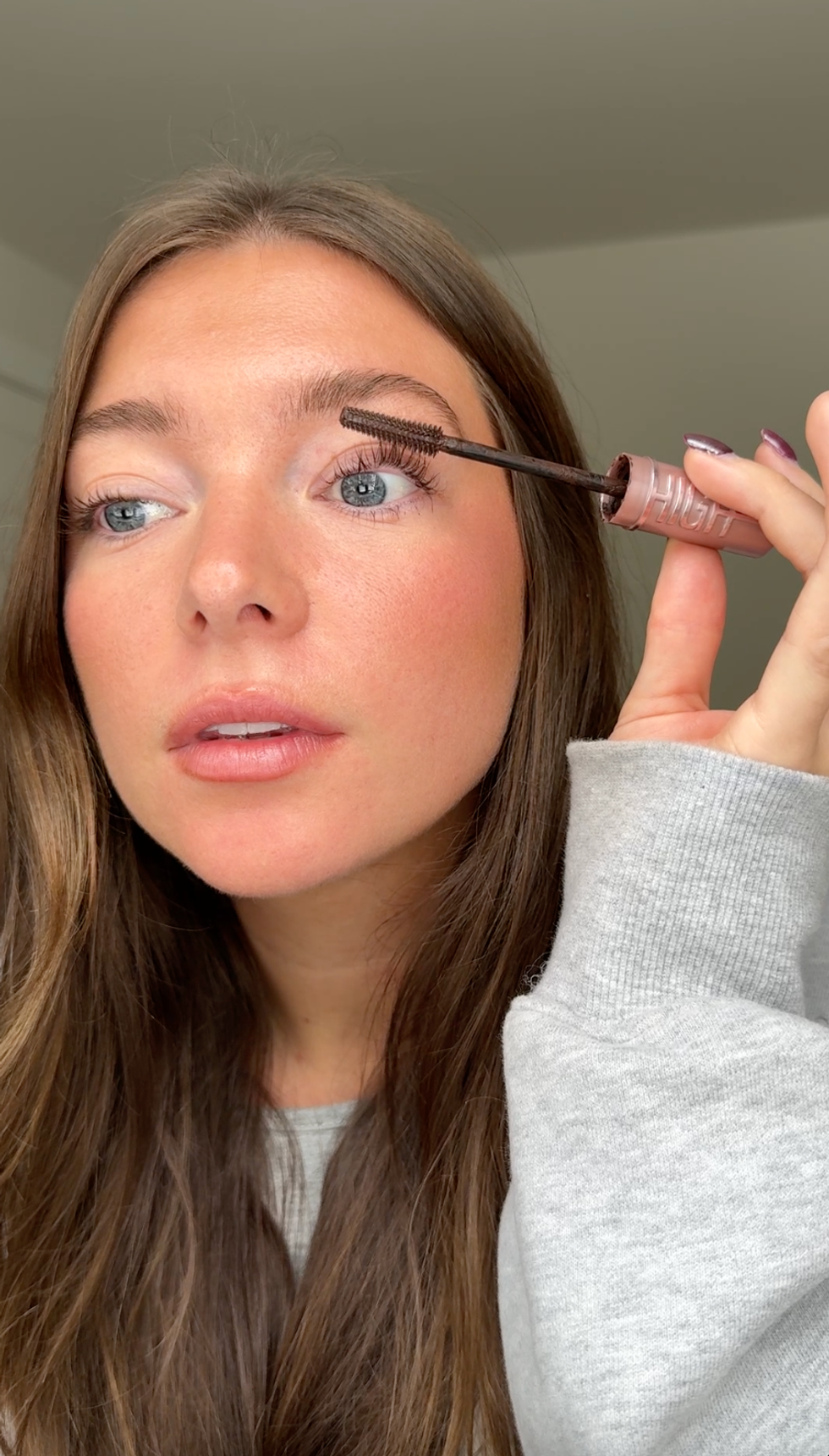 Person using mascara.