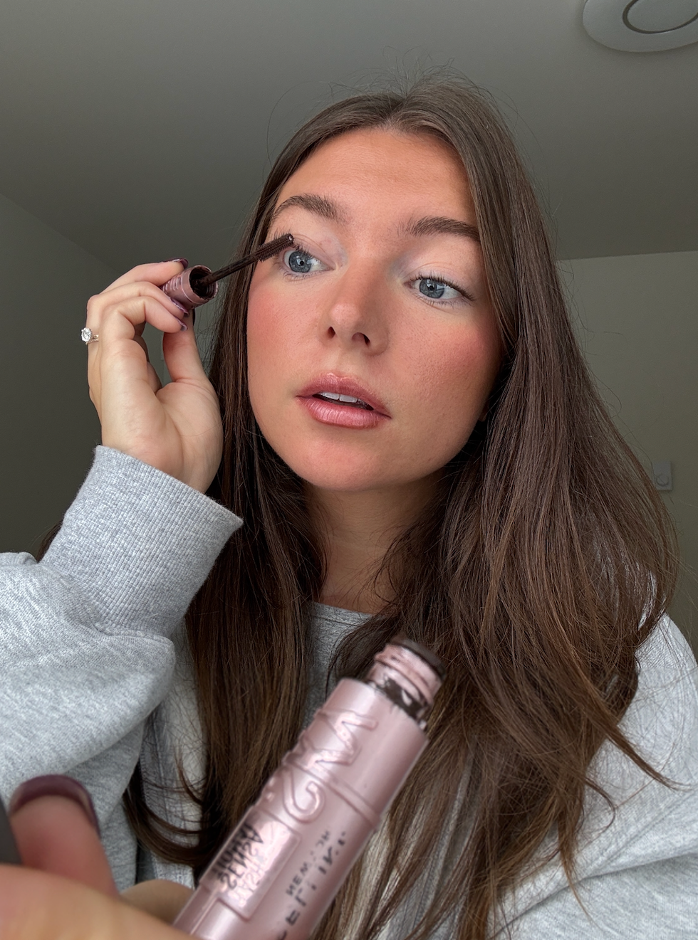 Person using mascara.