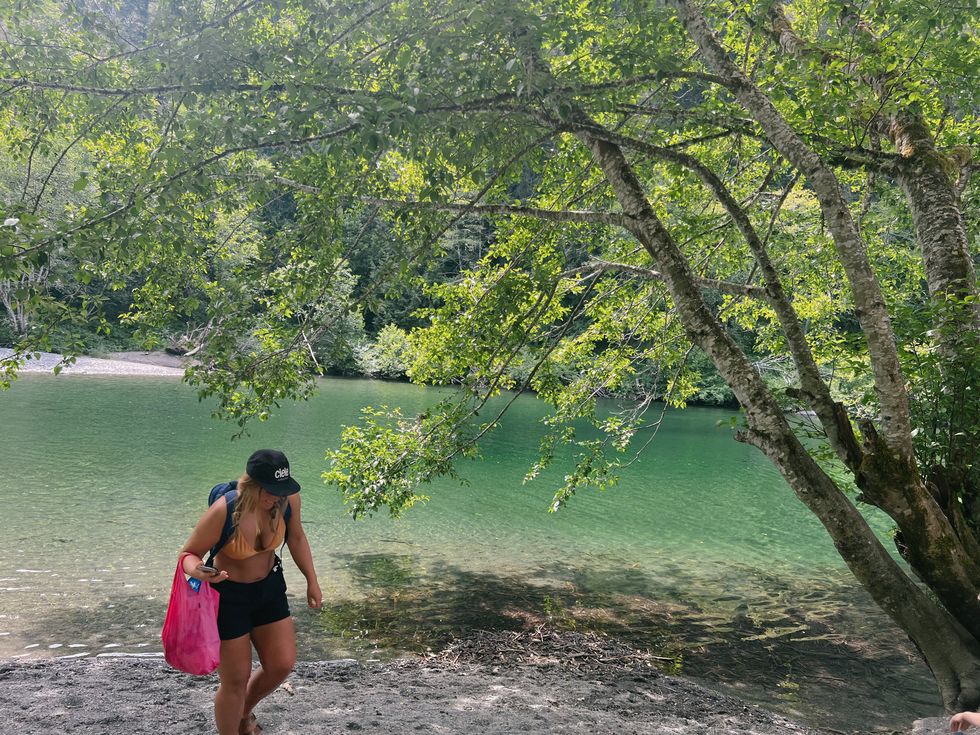 Person walking by the river in Sooke Potholes Provincial Park.