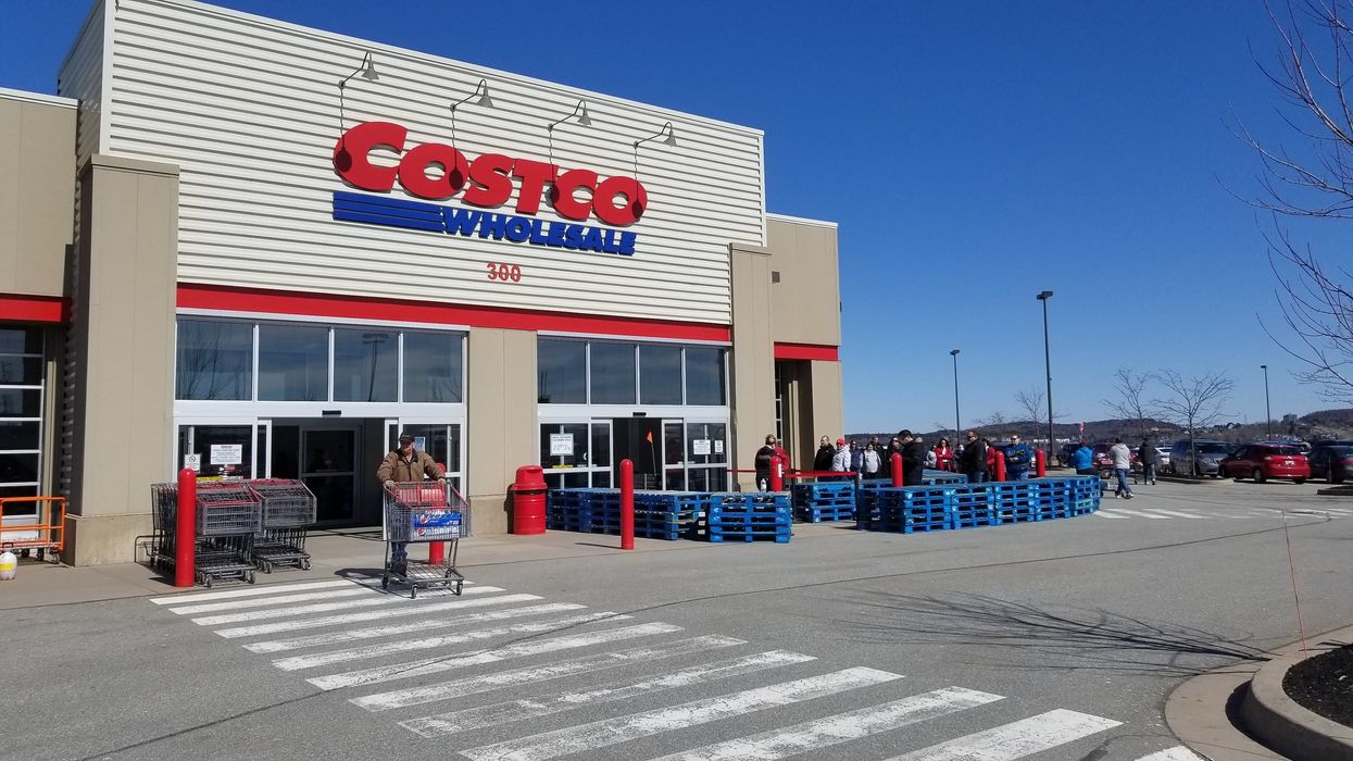 person walking out of costco store in canada with a shopping cart