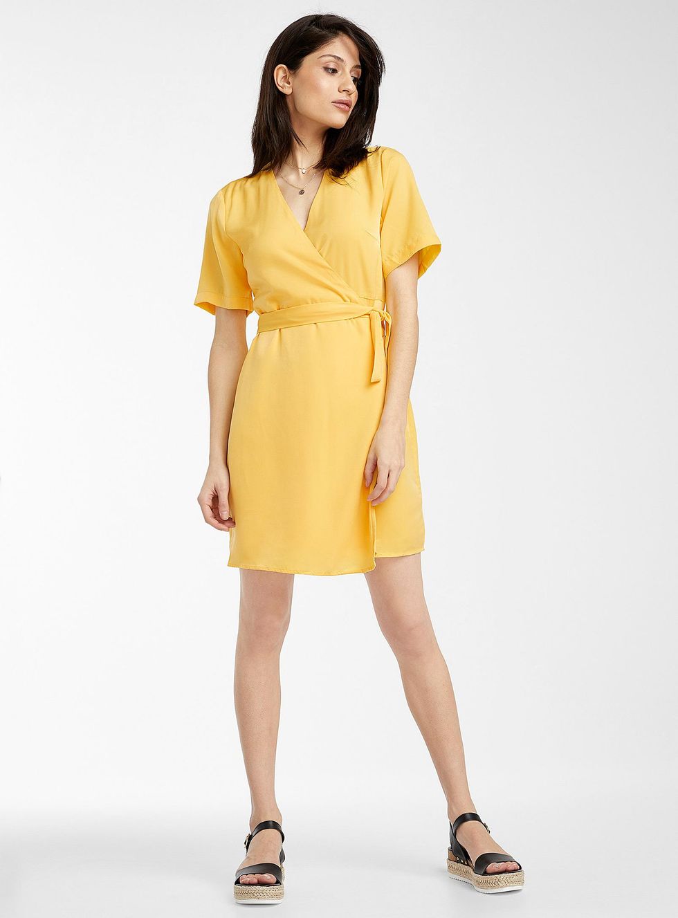 person wearing the wrap dress with sandals