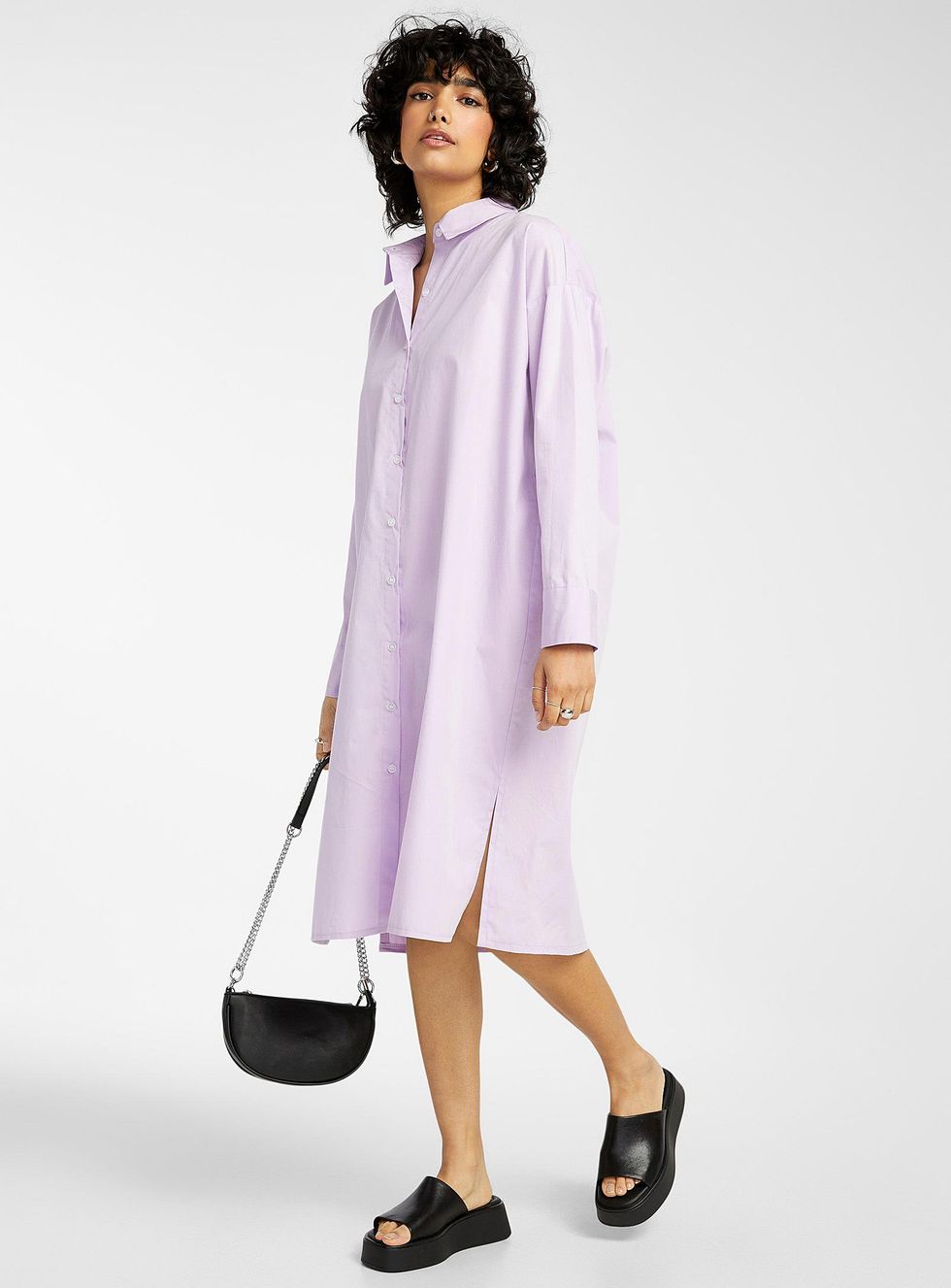 person with shirt dress with slides and small half moon purse