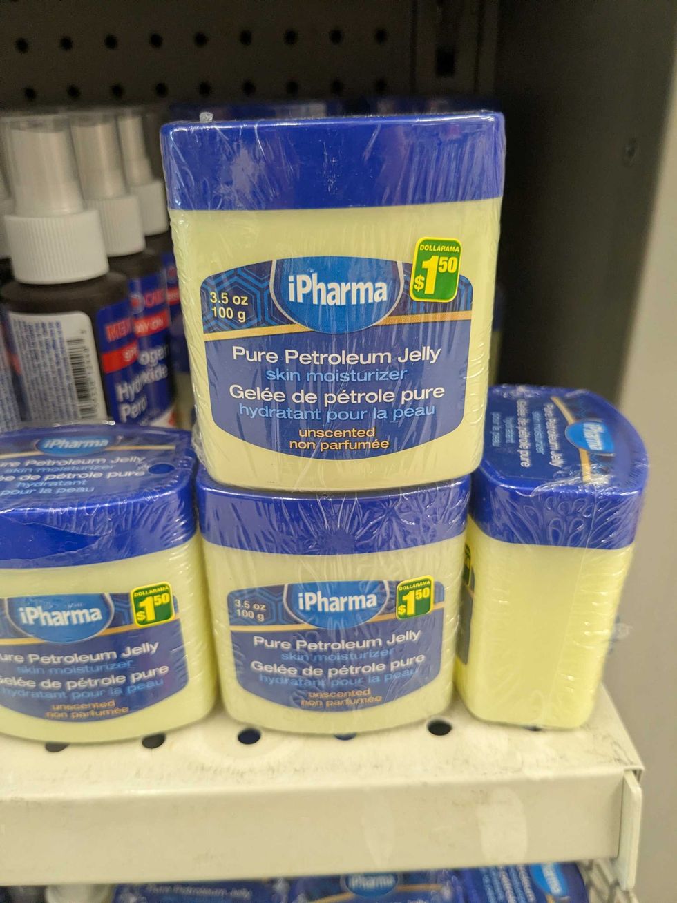 Petroleum jelly tubs on a shelf at Dollarama