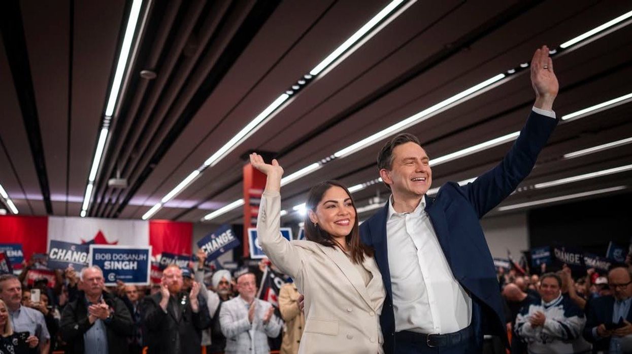 pierre poilievre waving with his wife at an election campaign event