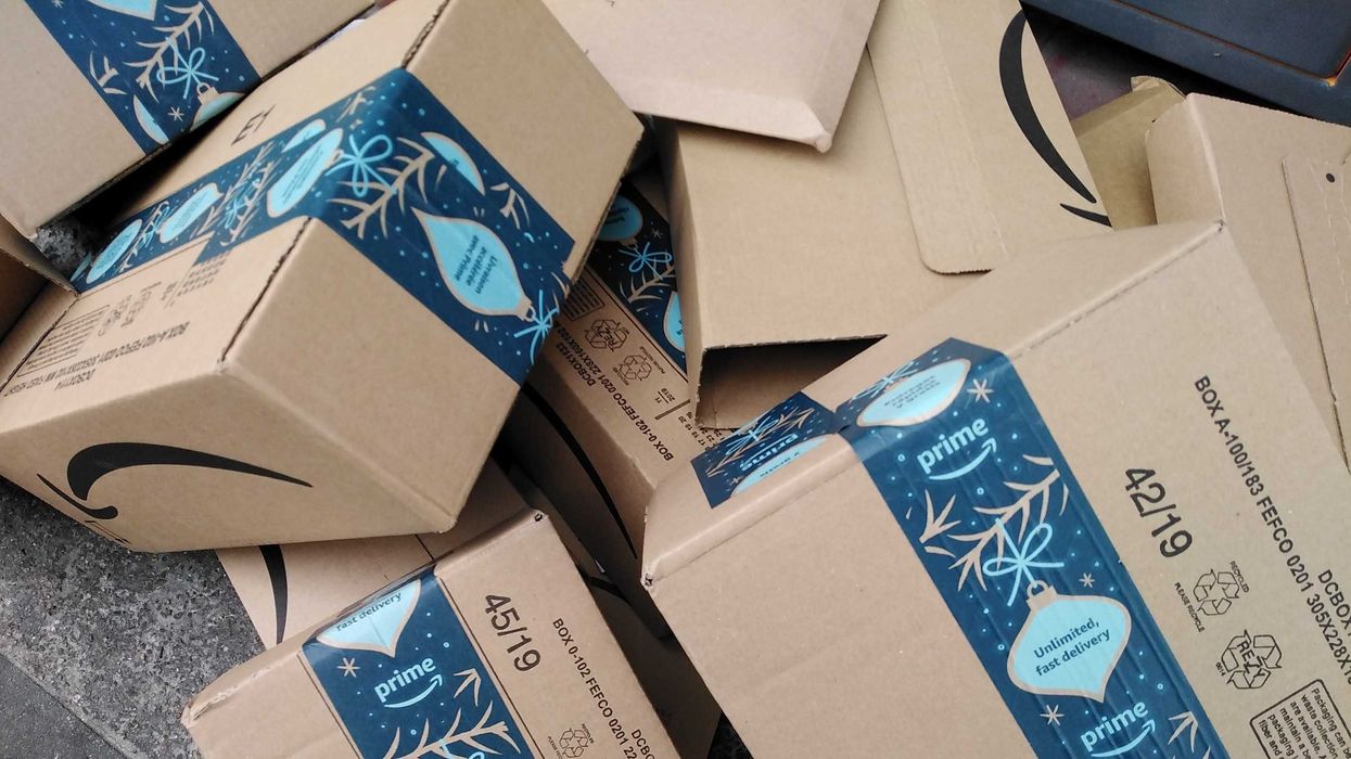 pile of amazon boxes with blue prime tape