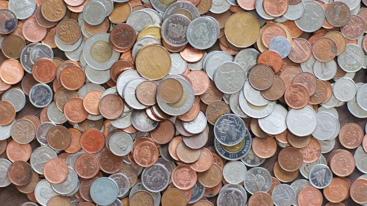 pile of canadian coins with pennies, dimes, quarters, loonies and toonies