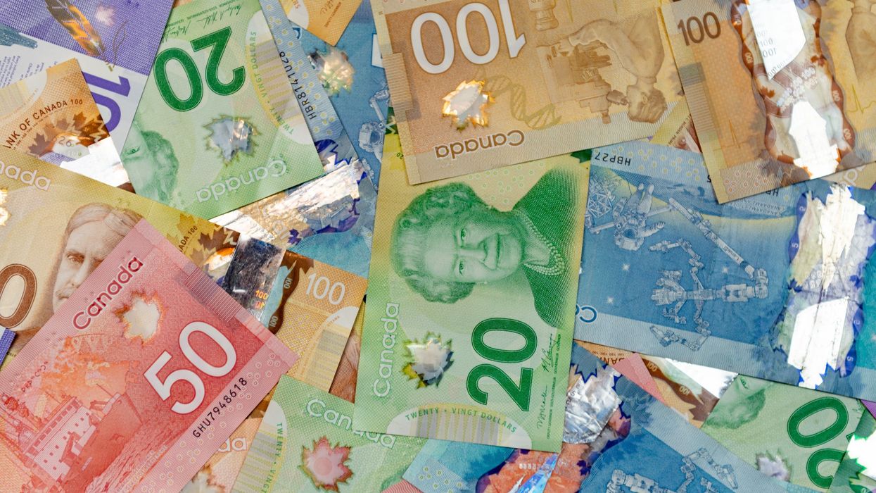 pile of canadian money with $5, $10, $20, $50 and $100 bills