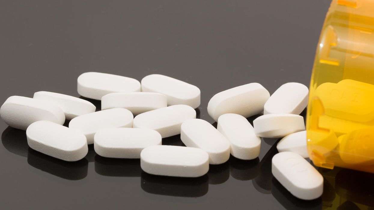 Pills spilling out of a bottle.