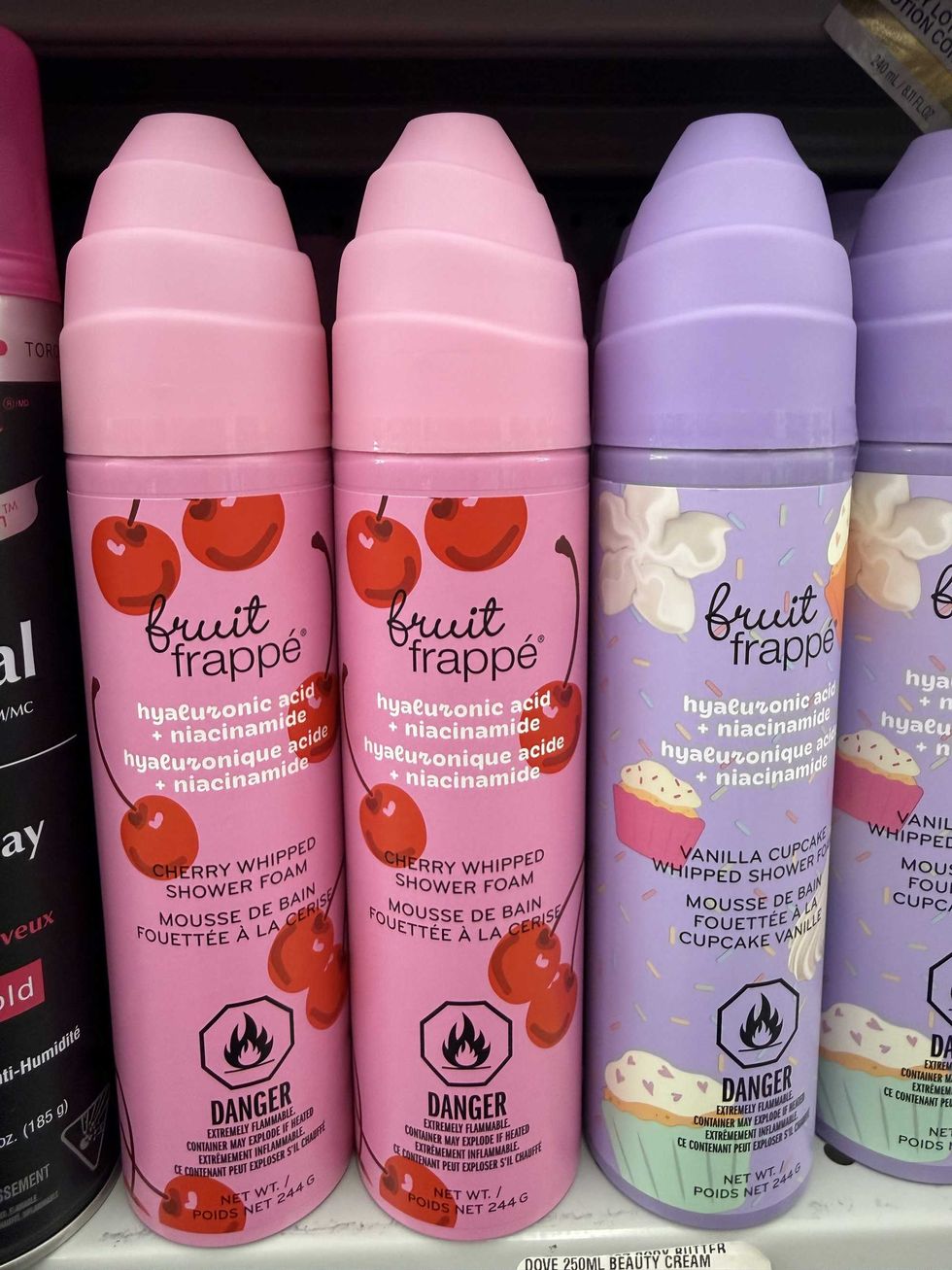 Pink and purple canisters with cherries and cupcakes on them that say "fruit frapp\u00e9 shower foam."