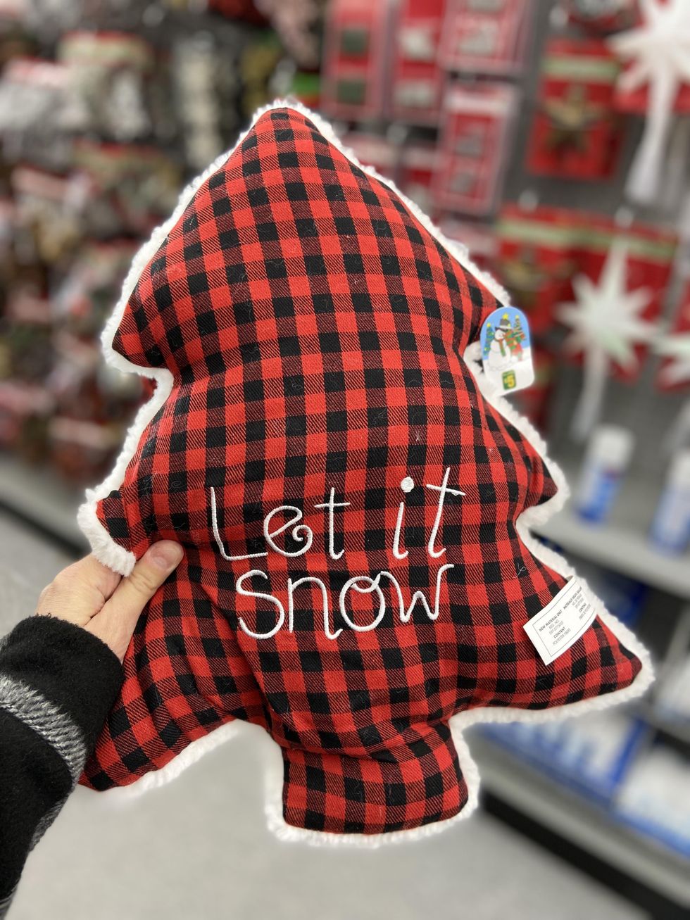 Plaid tree shaped pillow with the words 'let it snow'.