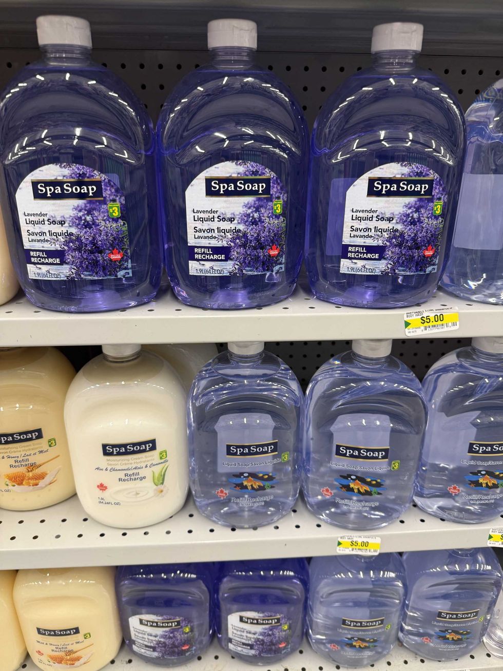 Plastic bottles with clear liquid, qhite liquid and yellow liquid in them and the label reading liquid soap.