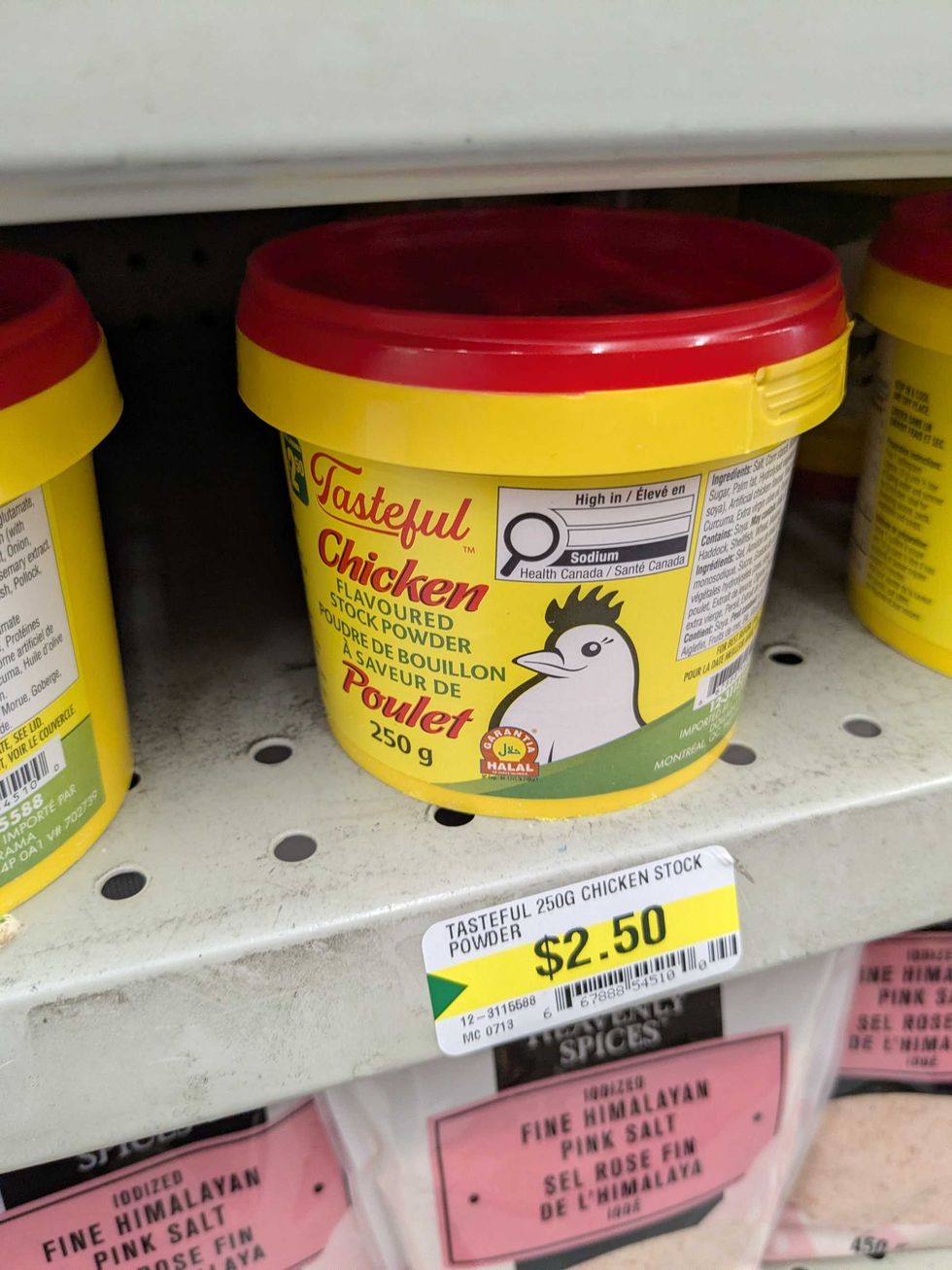 Plastic tubs of chicken stock powder on the shelf at Dollarama