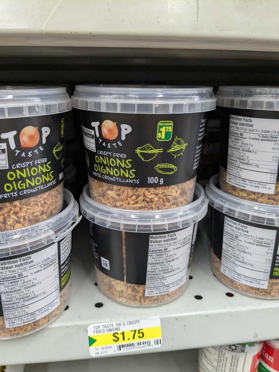 Plastic tubs of crispy fried onions on the shelf at Dollarama