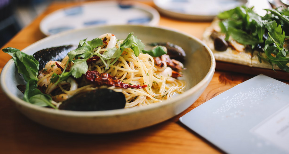 plate of pasta with seafood on a table