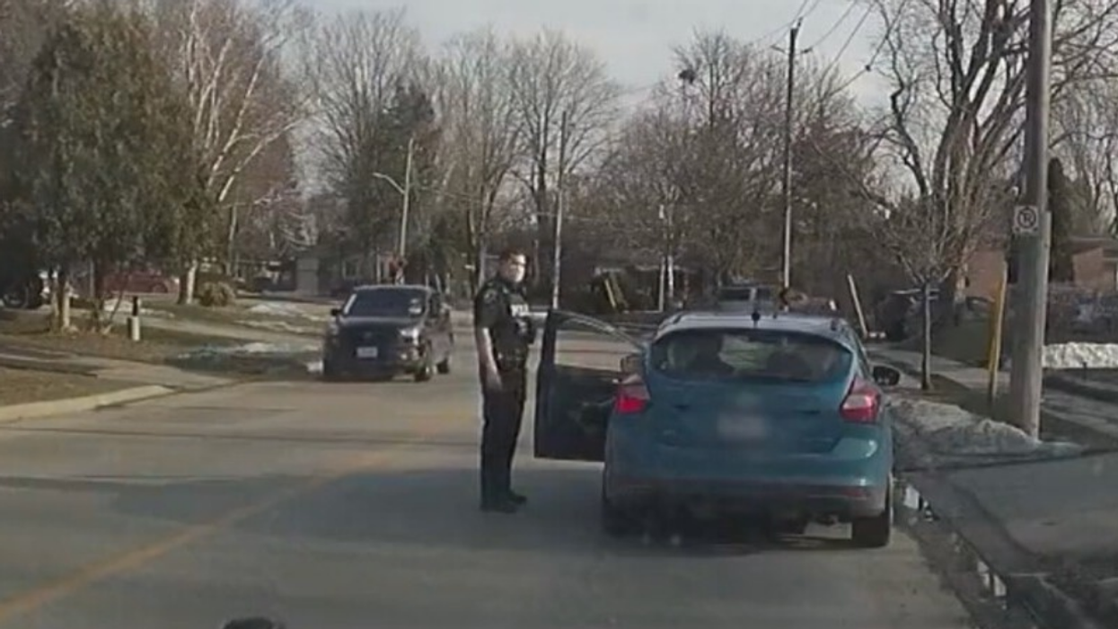 Police officer stops impaired driver.