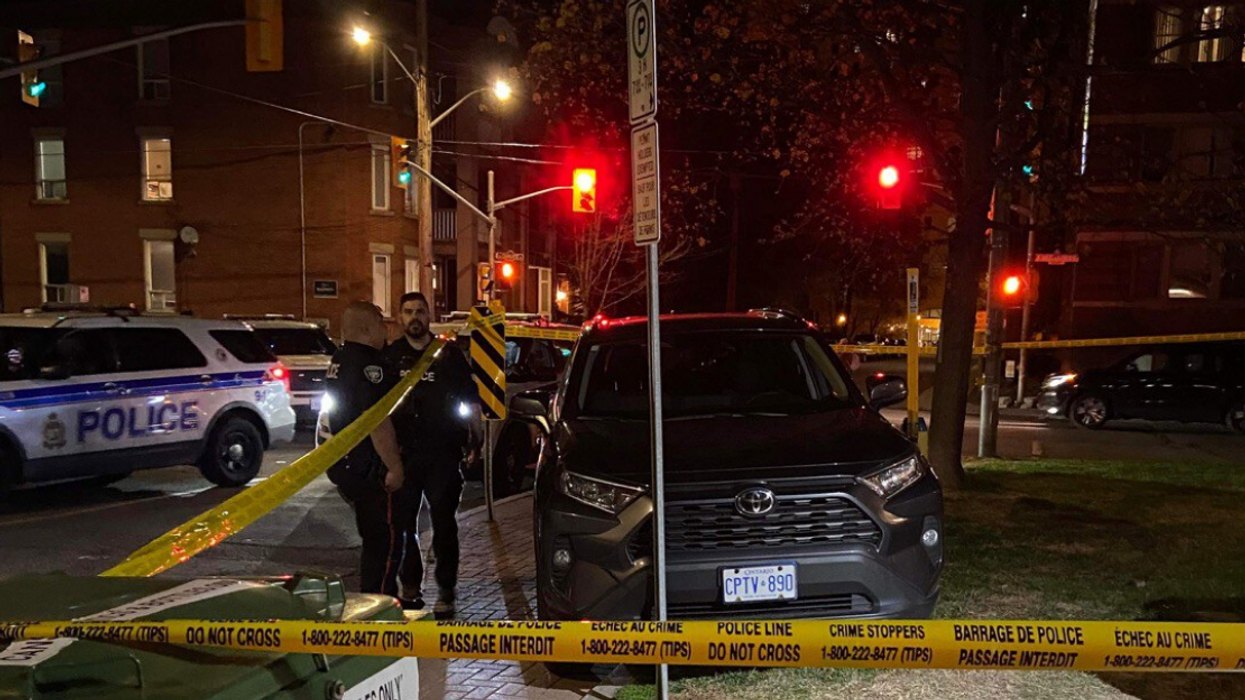 Police officers by Vanessa Fortino's stolen Toyota RAV4 surrounded by yellow police tape.