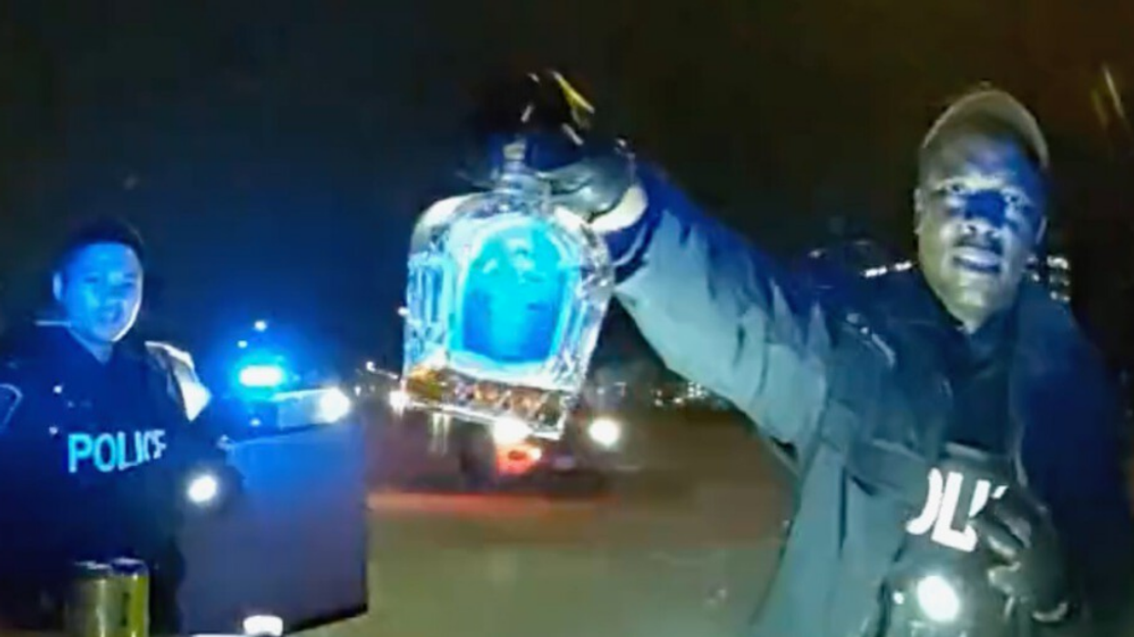 Police officers with confiscated liquor.