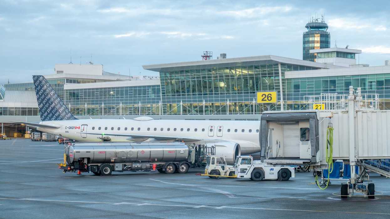 porter airlines plane at vancouver airport with control tower in background