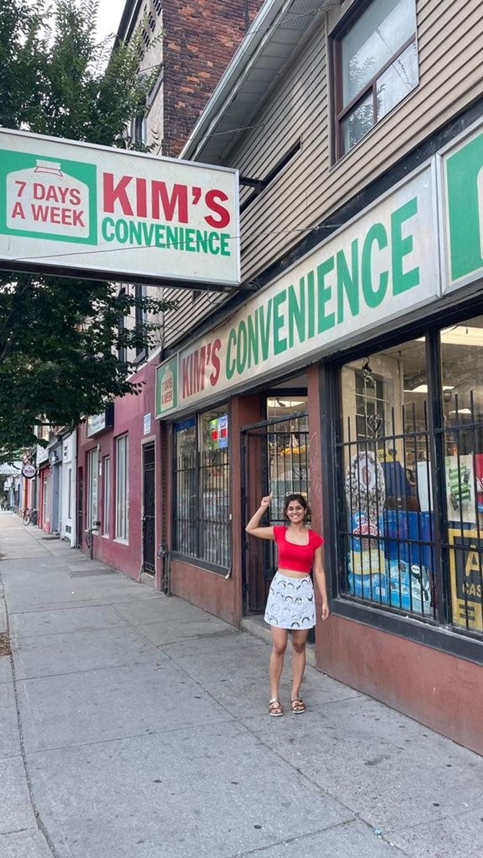 Posing in front of the Kim's Convenience store in Toronto.