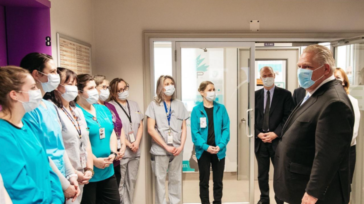 Premier Doug Ford with a group of hospital workers.