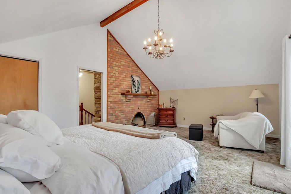 Primary bedroom with a wood-burning fireplace.