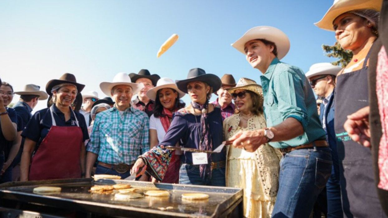 Prime Minister Justin Trudeau flipping pancakes at a Calgary Stampede breakfast.