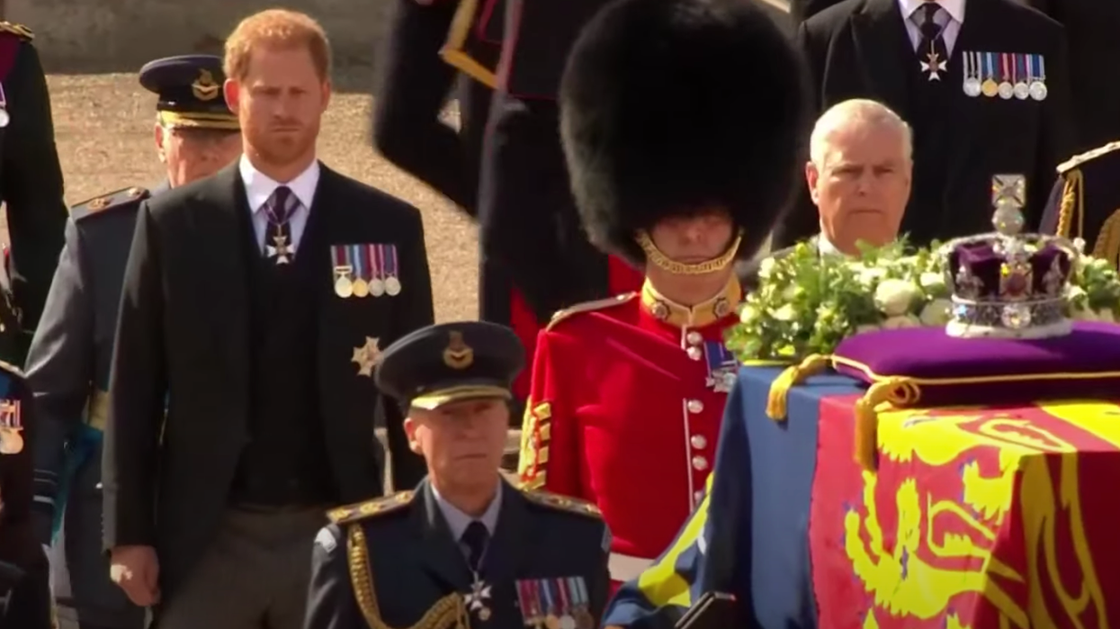 Prince Harry and Prince Andrew walking behind the queen's coffin in procession.