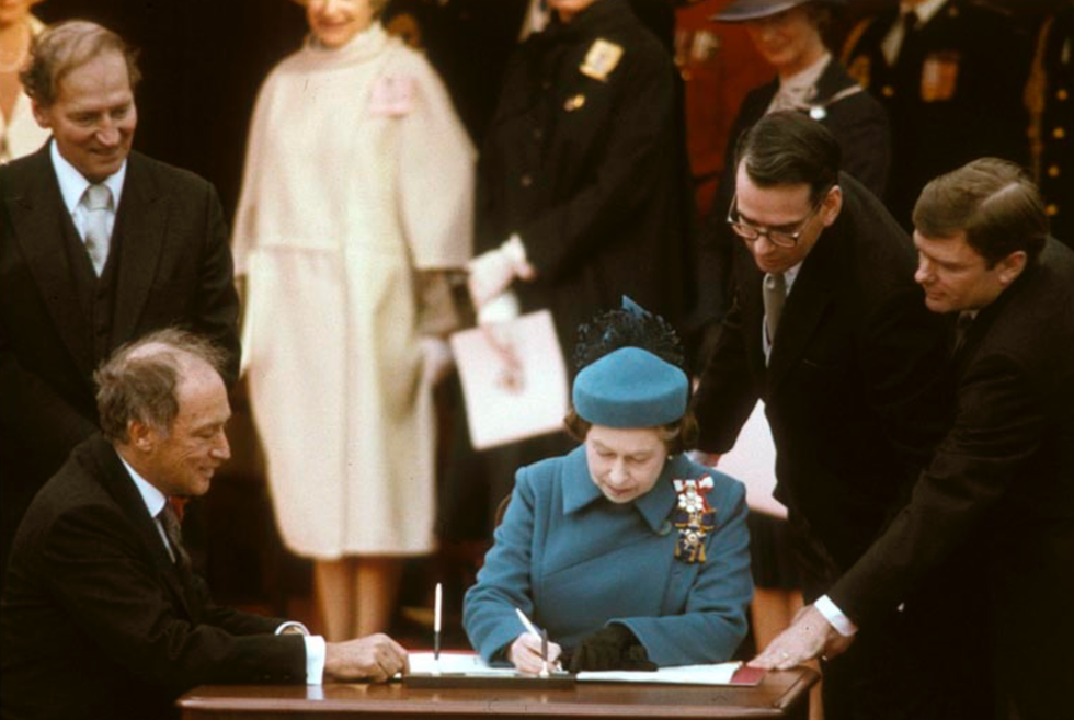 Queen Elizabeth II signs the Proclamation of the Constitution Act.