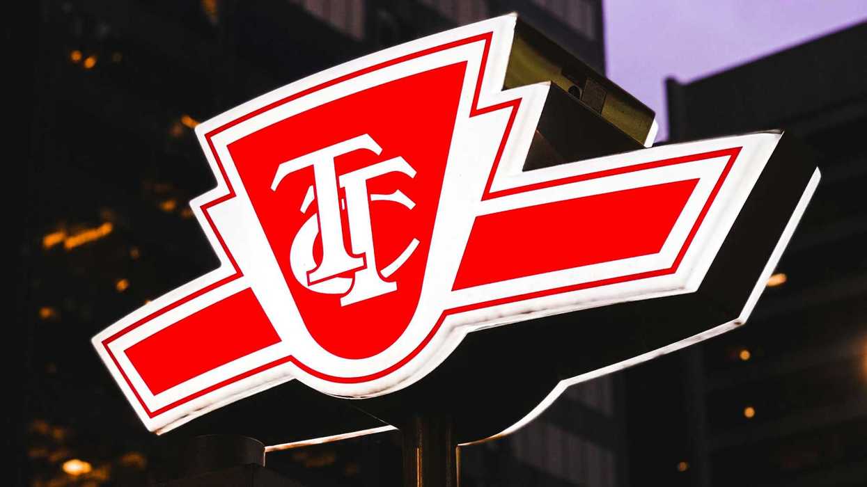 red and white ttc sign illuminated at night