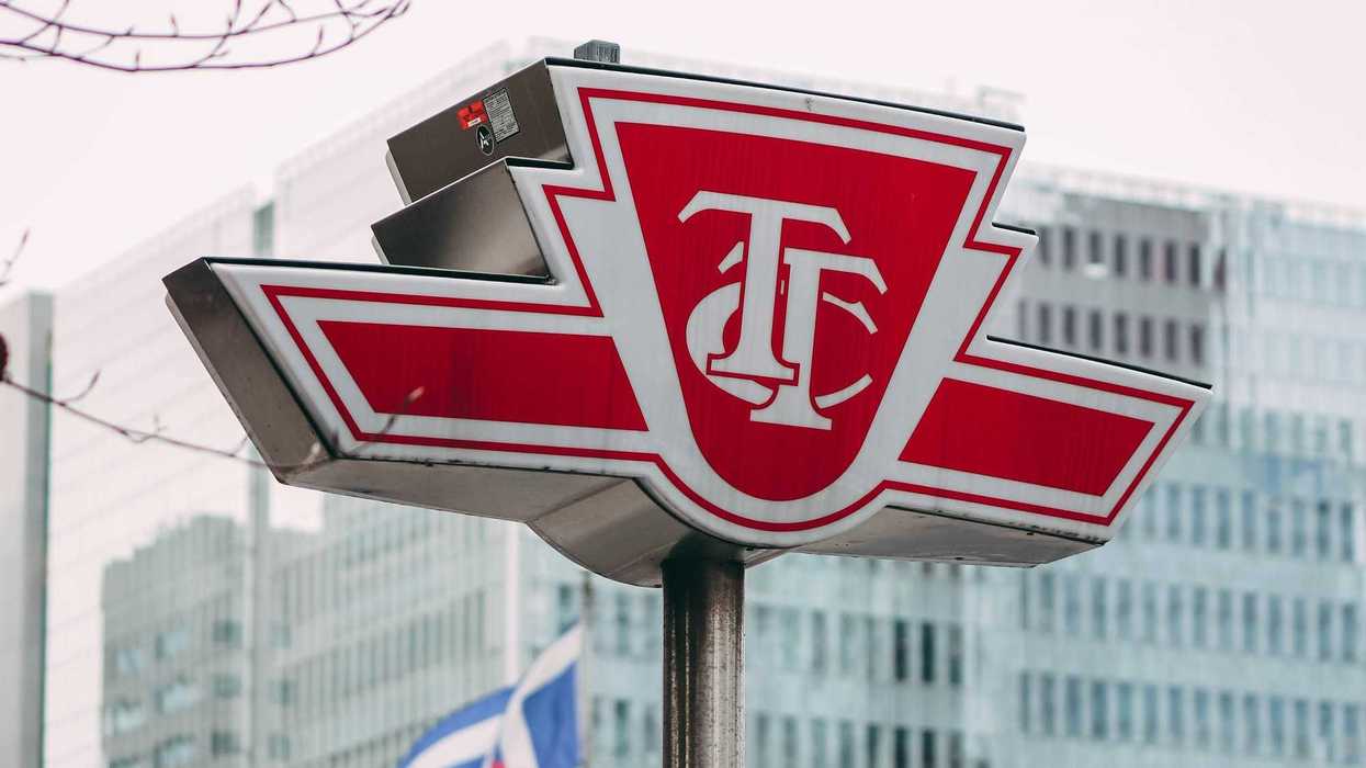 red and white ttc sign in front of building