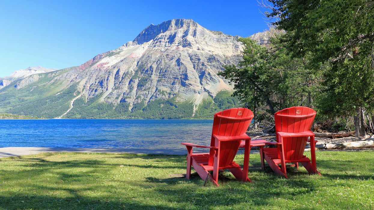 red parks canada chairs at a lake with a mountain at a national park in alberta
